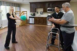 Riverwalk Post-Acute rehab therapist with a resident in the gym